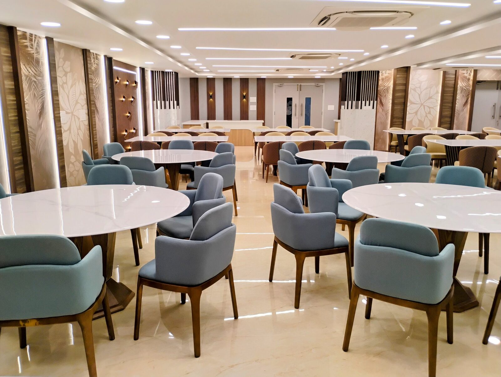 Staff cafeteria with banquette seating and feature lighting
