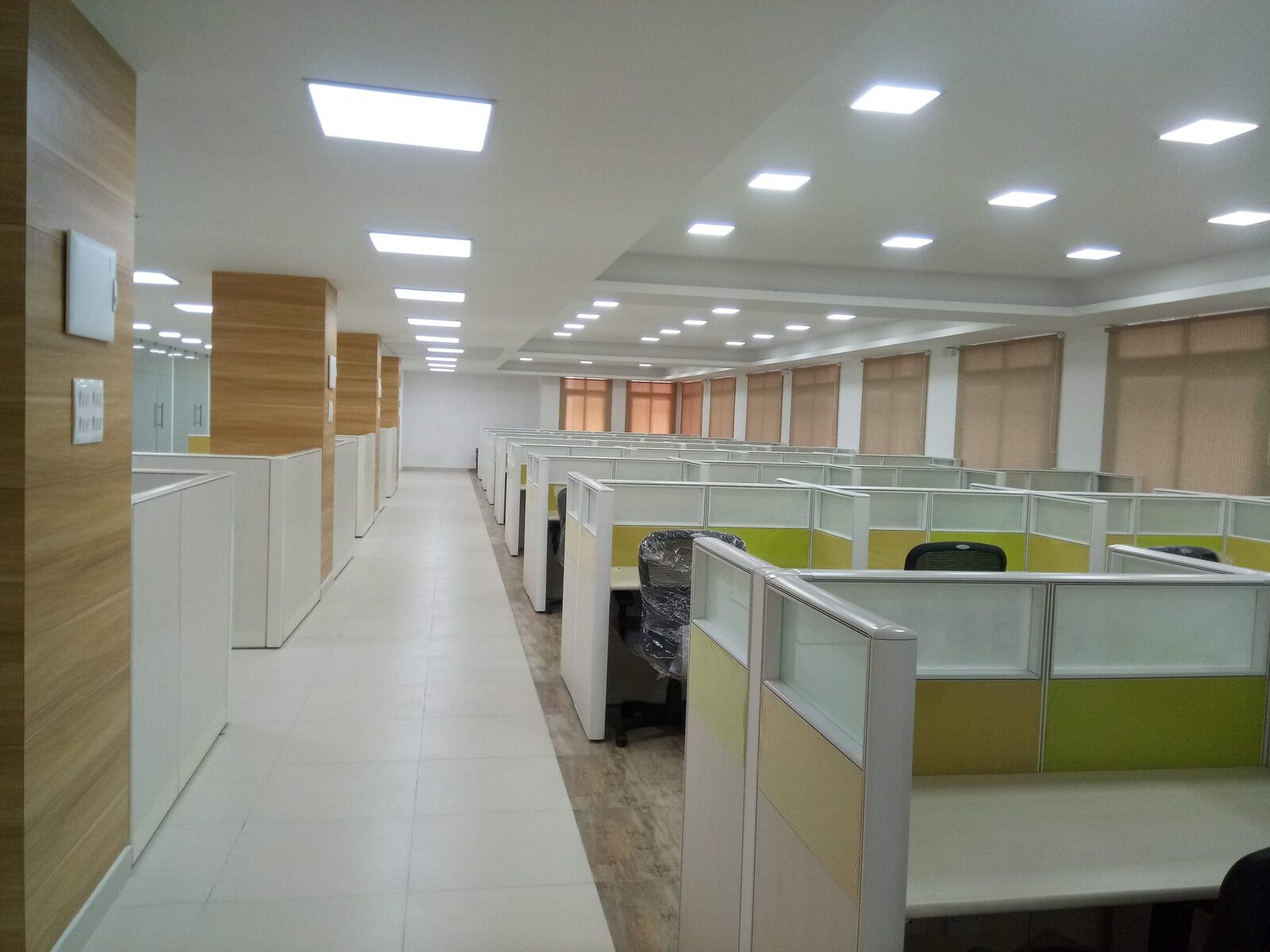 Open-plan office with modular workstations and screens