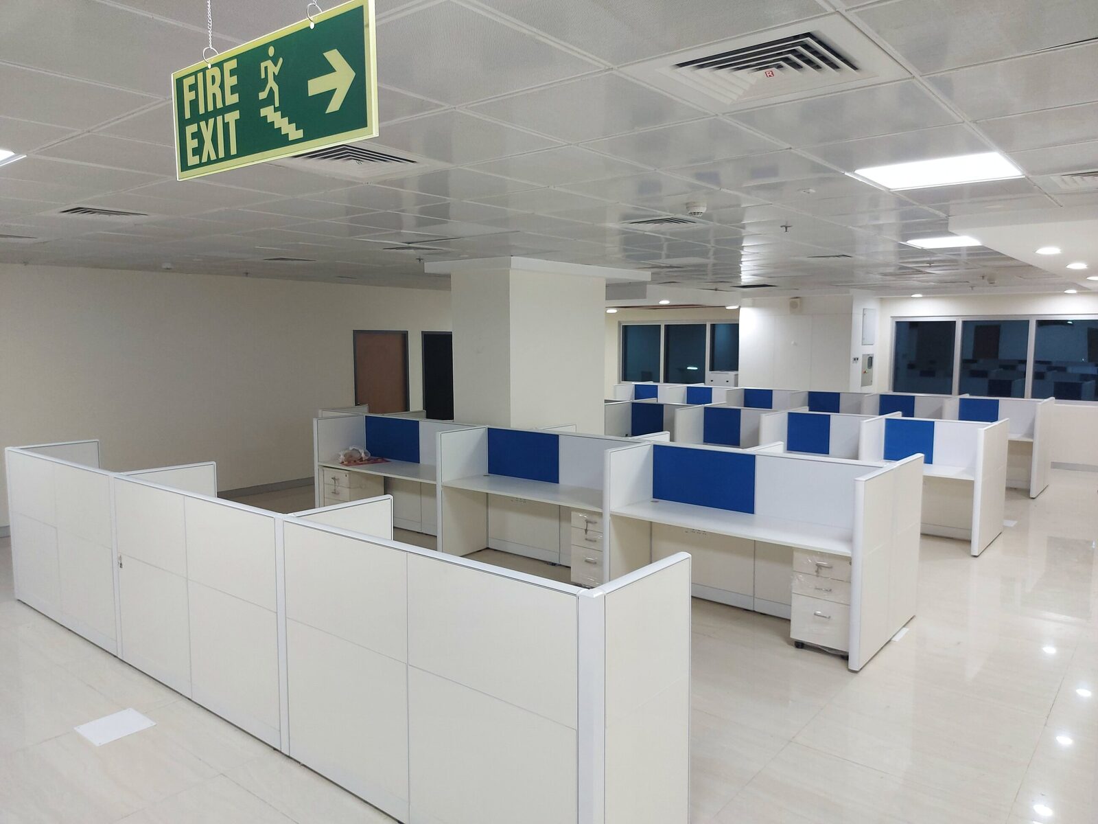 Office floor fitted out with modular workstations, screens and pedestals