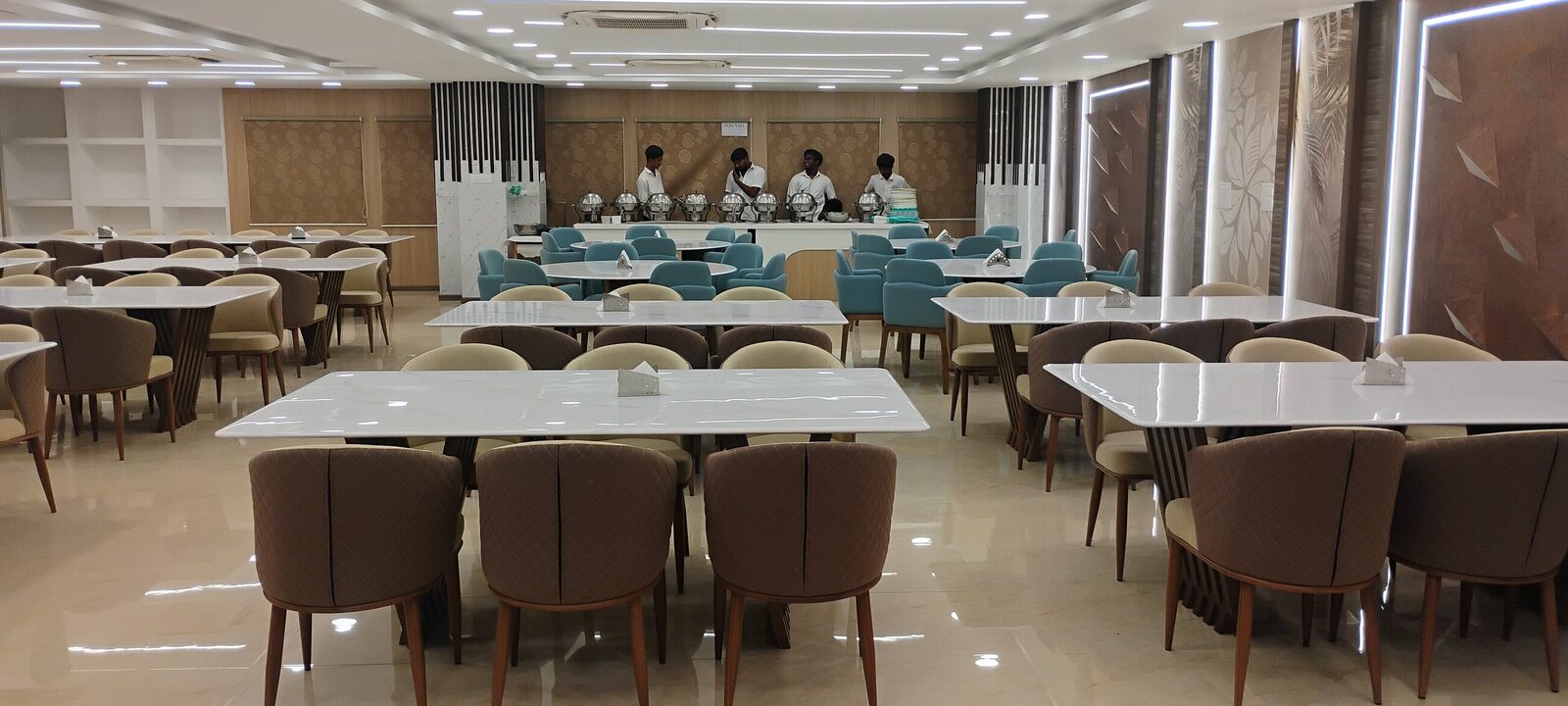 Large dining hall with banquet seating, service counter and false ceiling